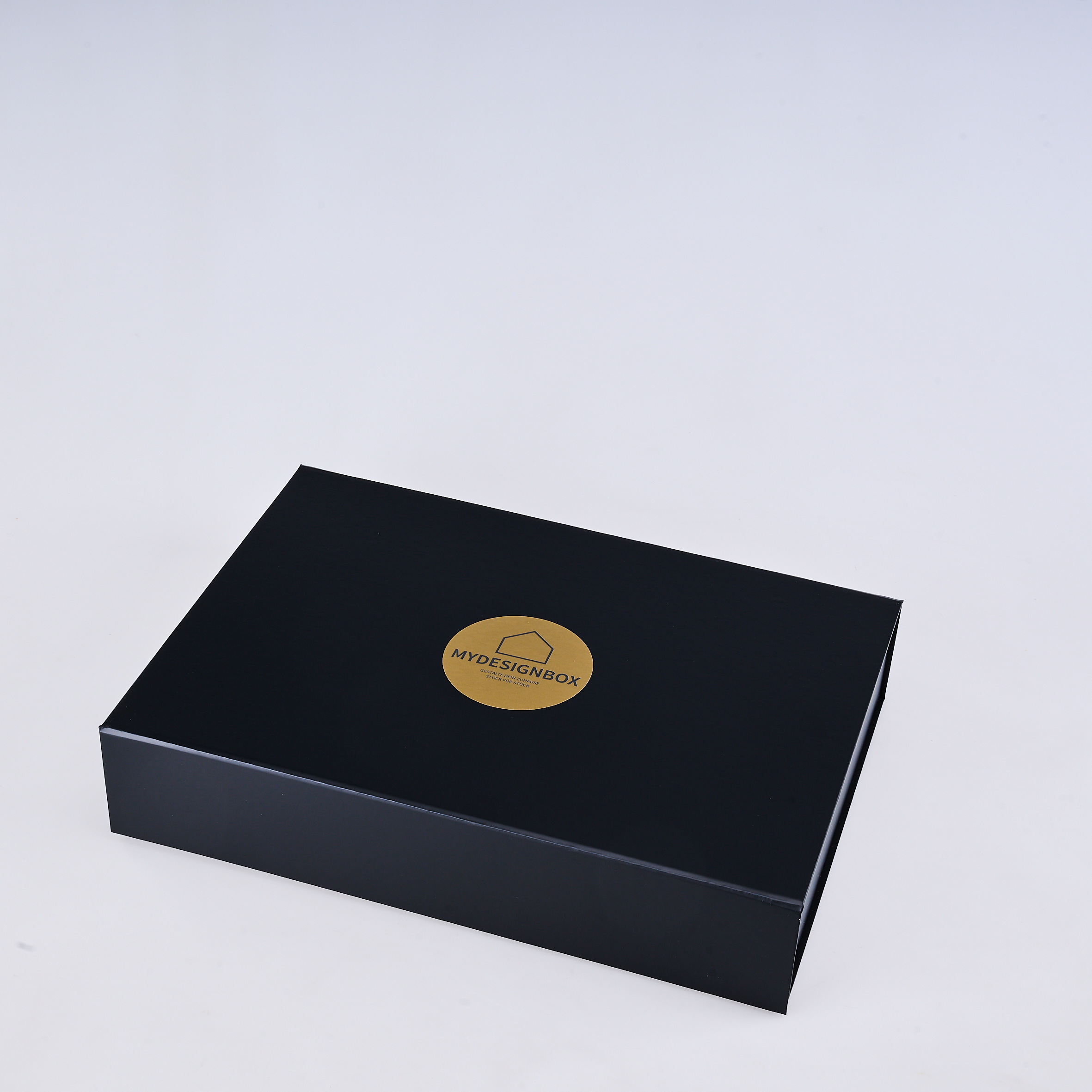 myDesignBox Gold von Melior: geschlossene schwarze Geschenkbox mit goldenem Logo